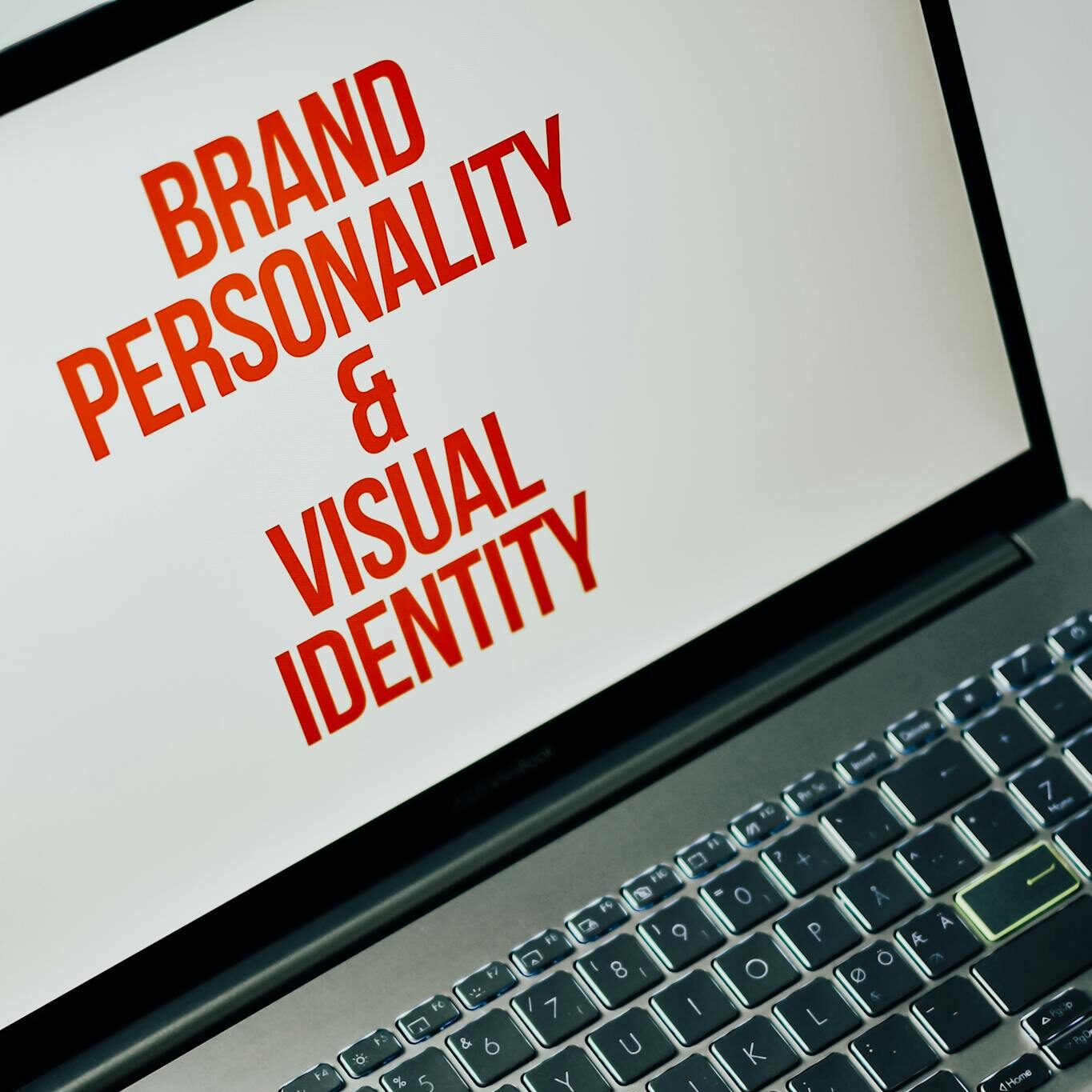 Laptop screen showing text on brand personality and visual identity for marketing strategy.